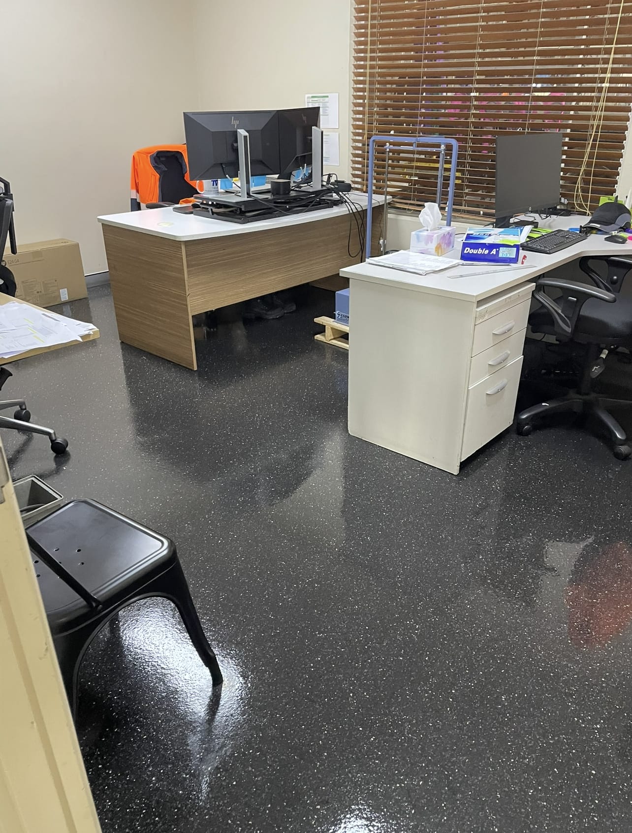 Polished speckled vinyl floor in an office
