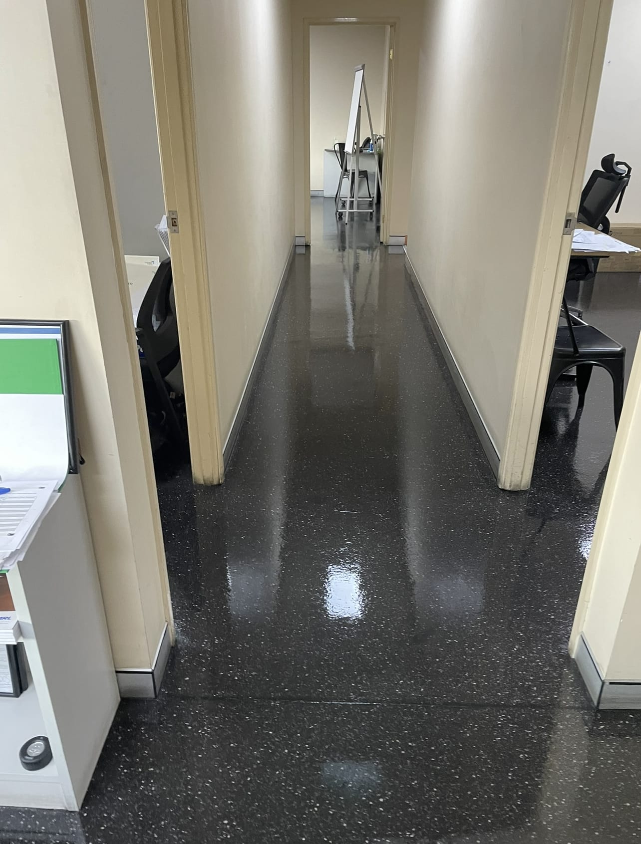 Glossy speckled floor in an office hallway