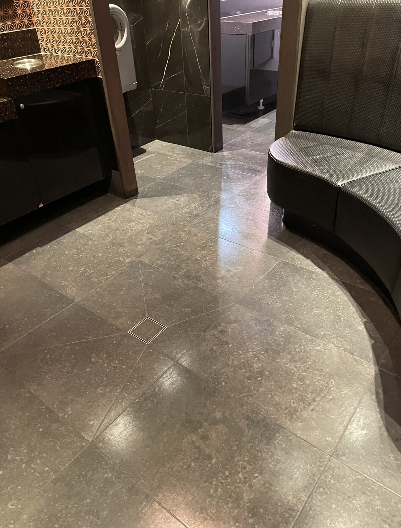 A polished stone floor cleaned to a shine by Cheetah Maintenance in a hospitality venue